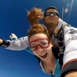 Female tandem jumper enjoying free fall