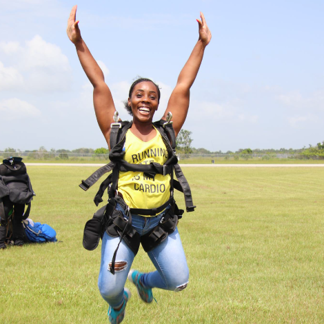 Female tandem jumper enjoying free fall